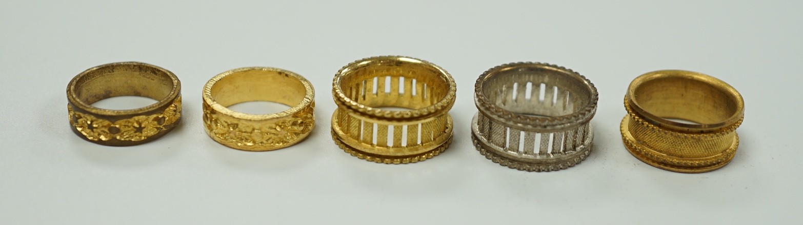 A rare Regency morocco leather mounted white metal cylindrical ring box containing five pinchbeck/base metal sample rings, box length 47mm.